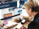 Conversion Content: Crafting Content That Moves Prospects from Attention to Action Business professional reviewing digital content on a desktop screen, illustrating a conversion-driven content strategy that supports decision-making, trust, and buyer readiness.